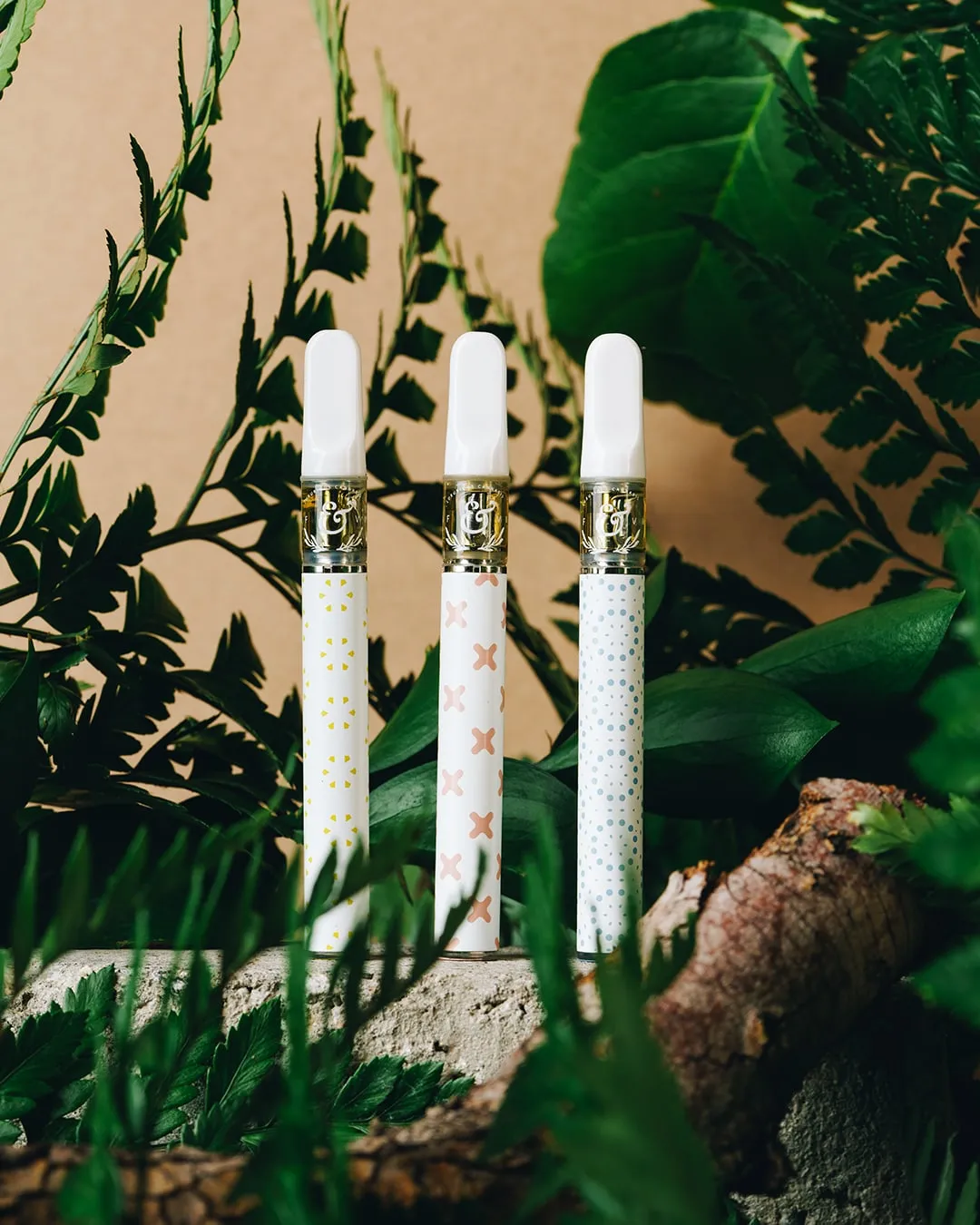 Three pre-rolls standing among green leaves