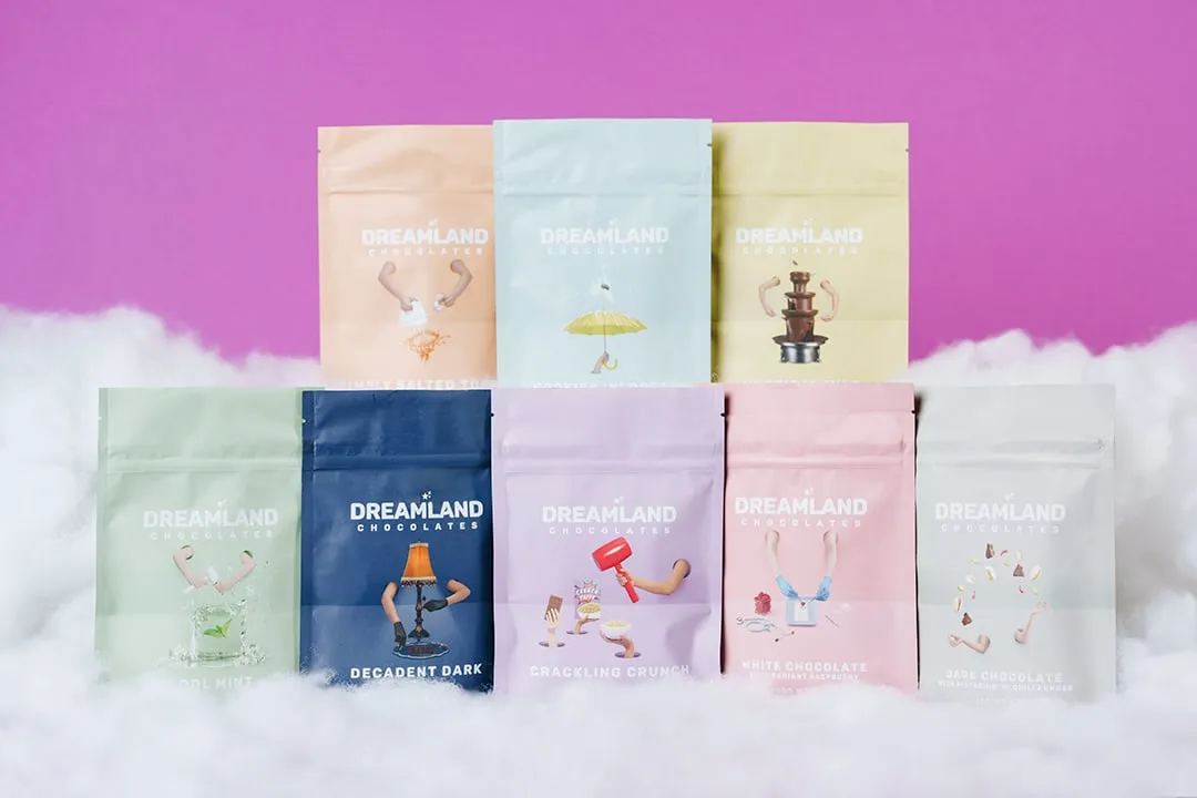 Ten Dreamland chocolate pouches stacked on a cloud of cotton