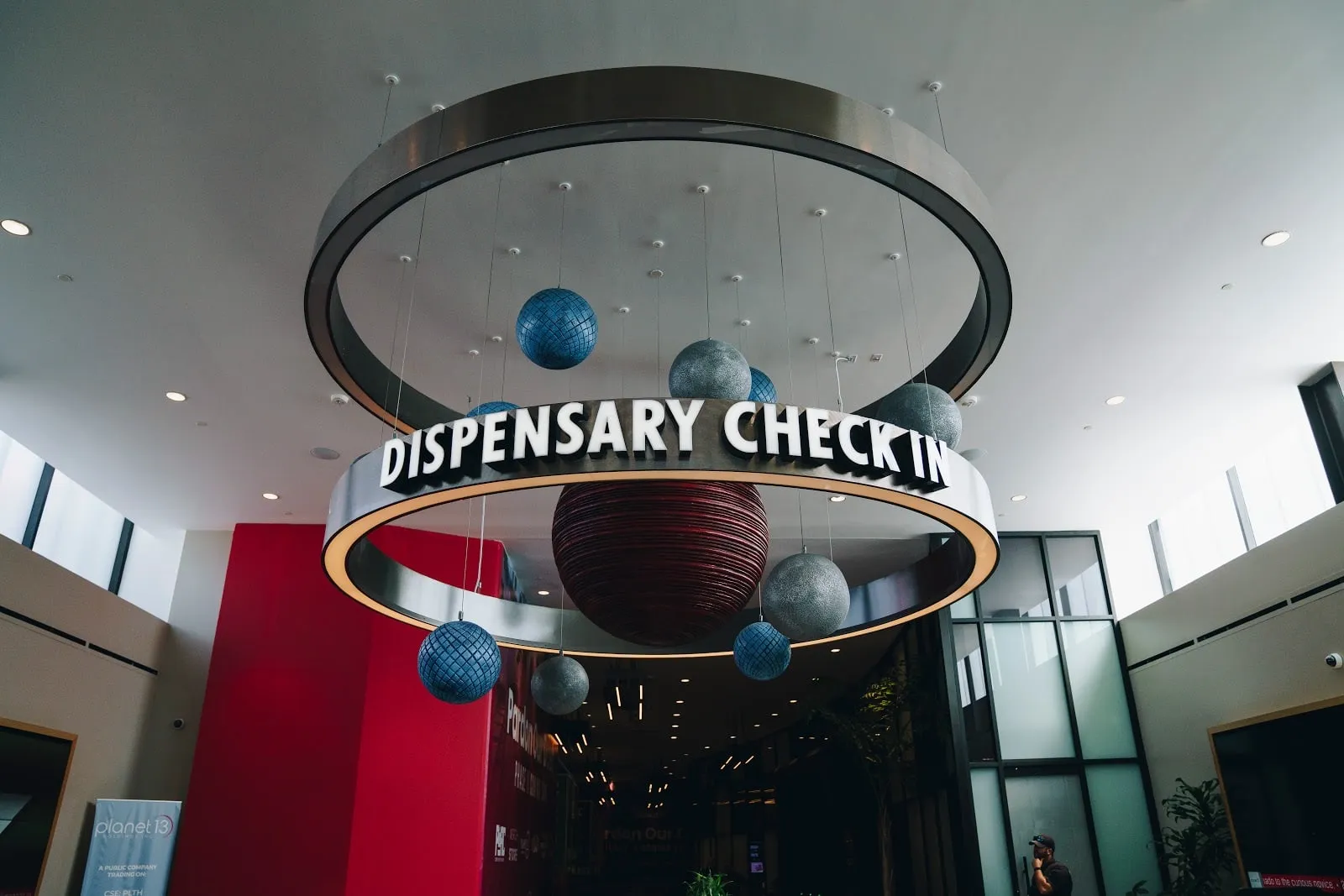 The Dispensary Check In sign in its ring of hanging spheres