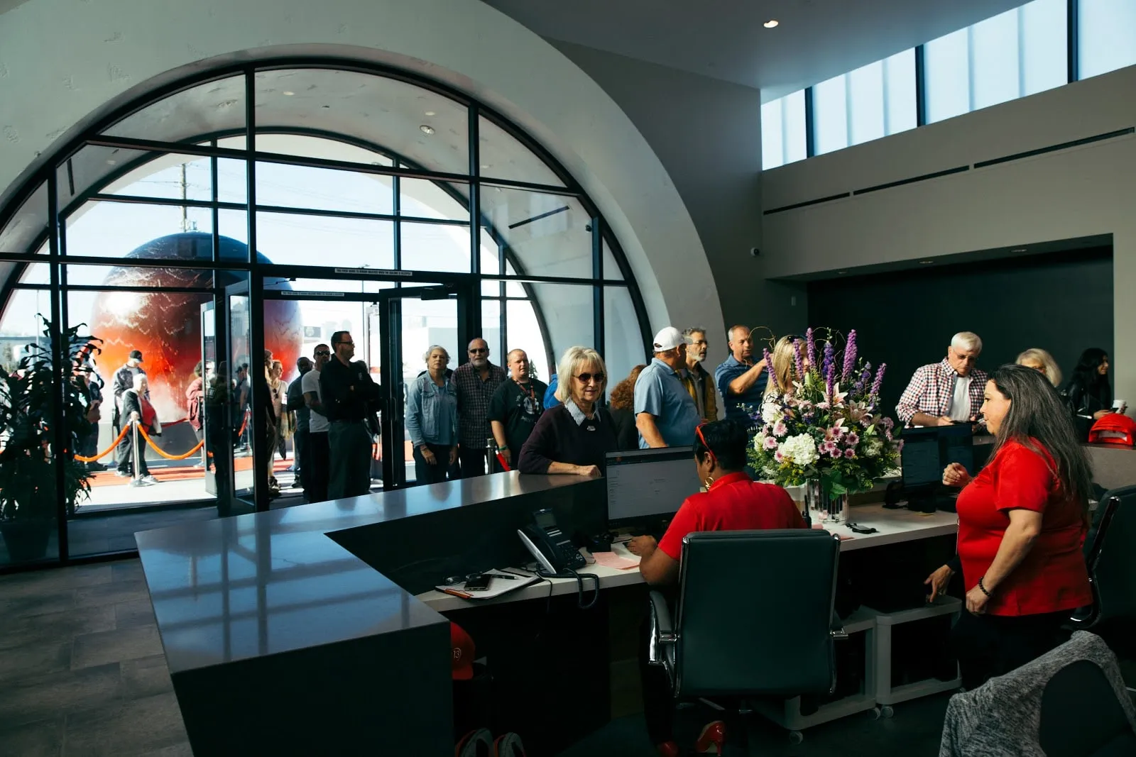 Guests checking in at the front desk inside the arched entrance