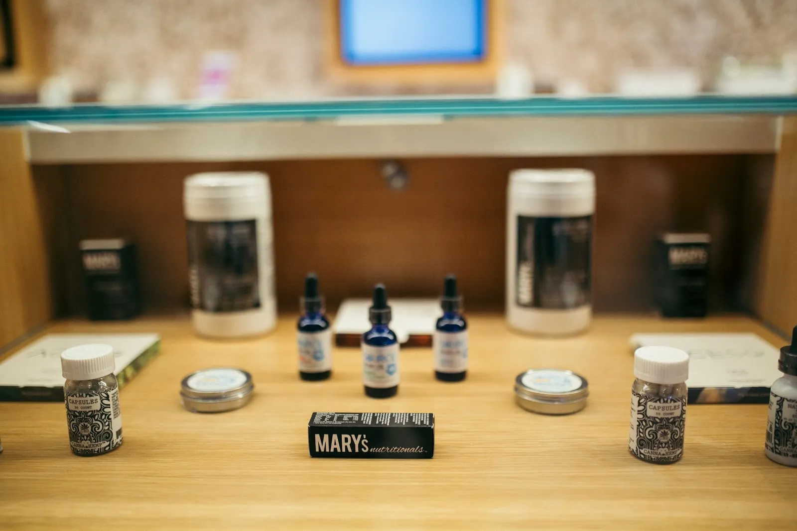 Tinctures and topicals on a lit shelf